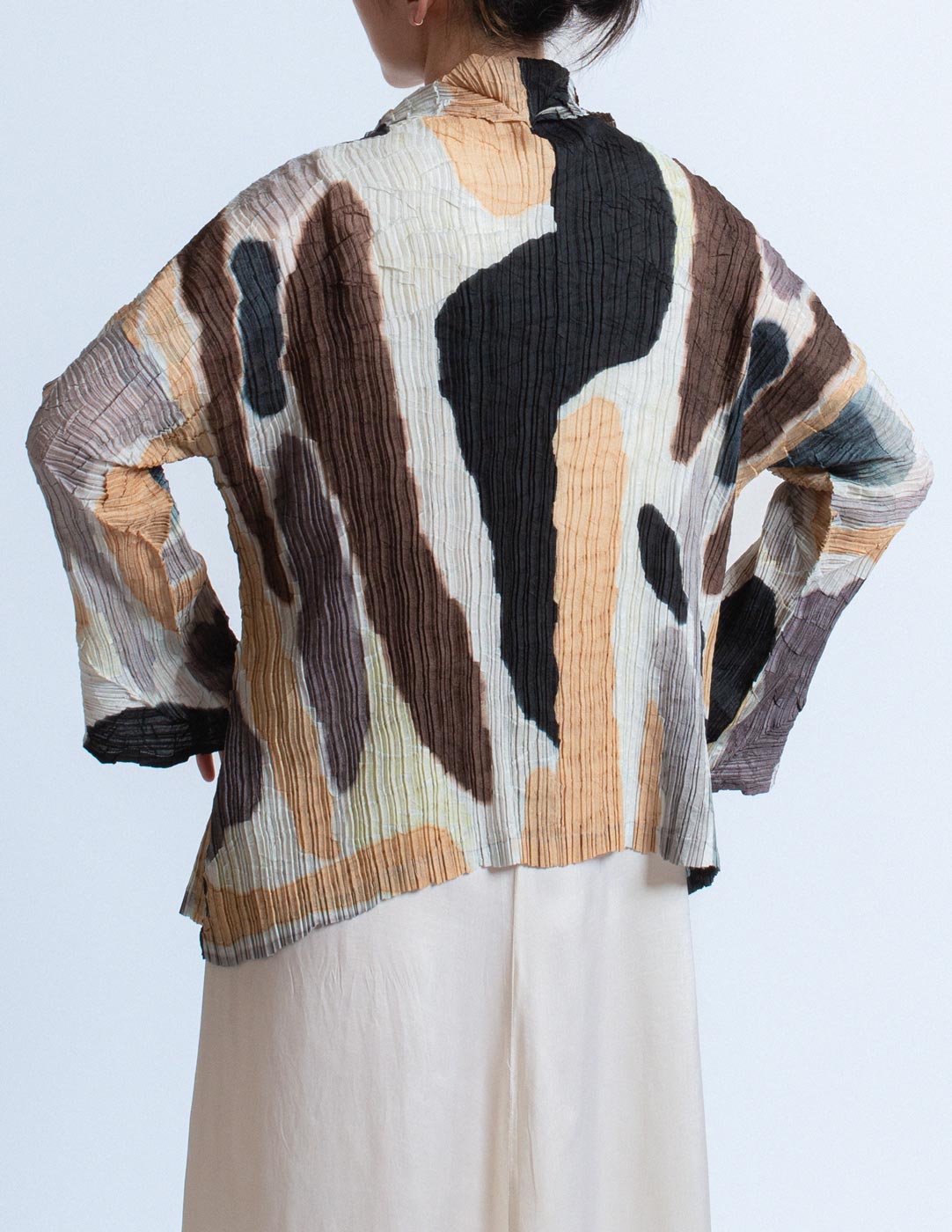 Issey Miyake earth tone pleated cardigan with abstract painterly pattern back detail