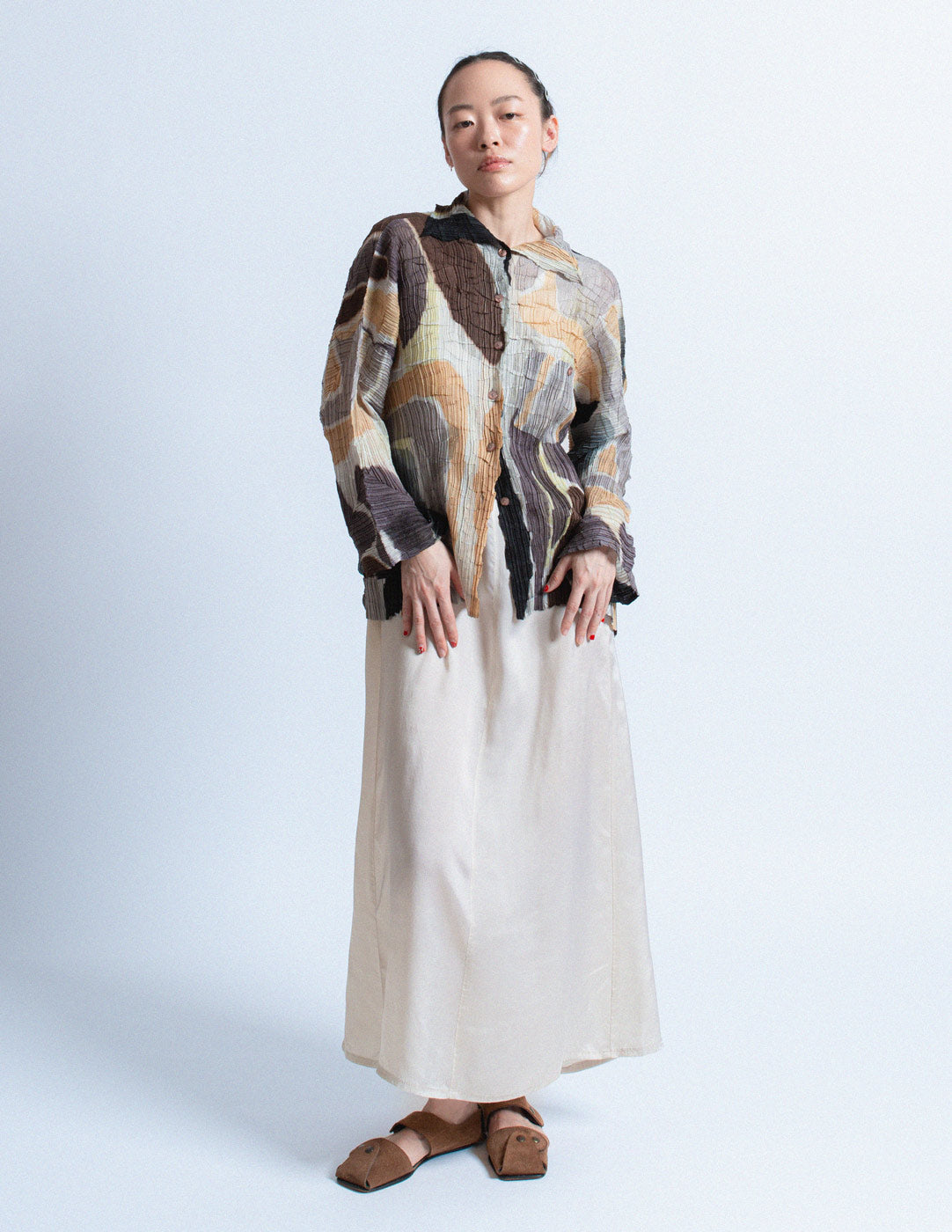 Issey Miyake earth tone pleated cardigan with abstract painterly pattern