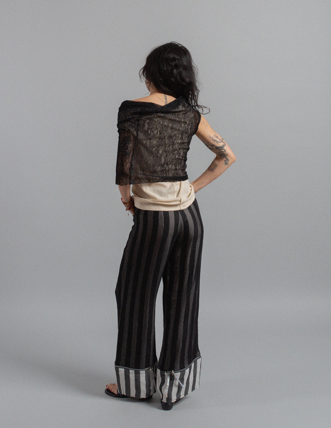 Issey Miyake layered striped trousers with zipped cuffs back view
