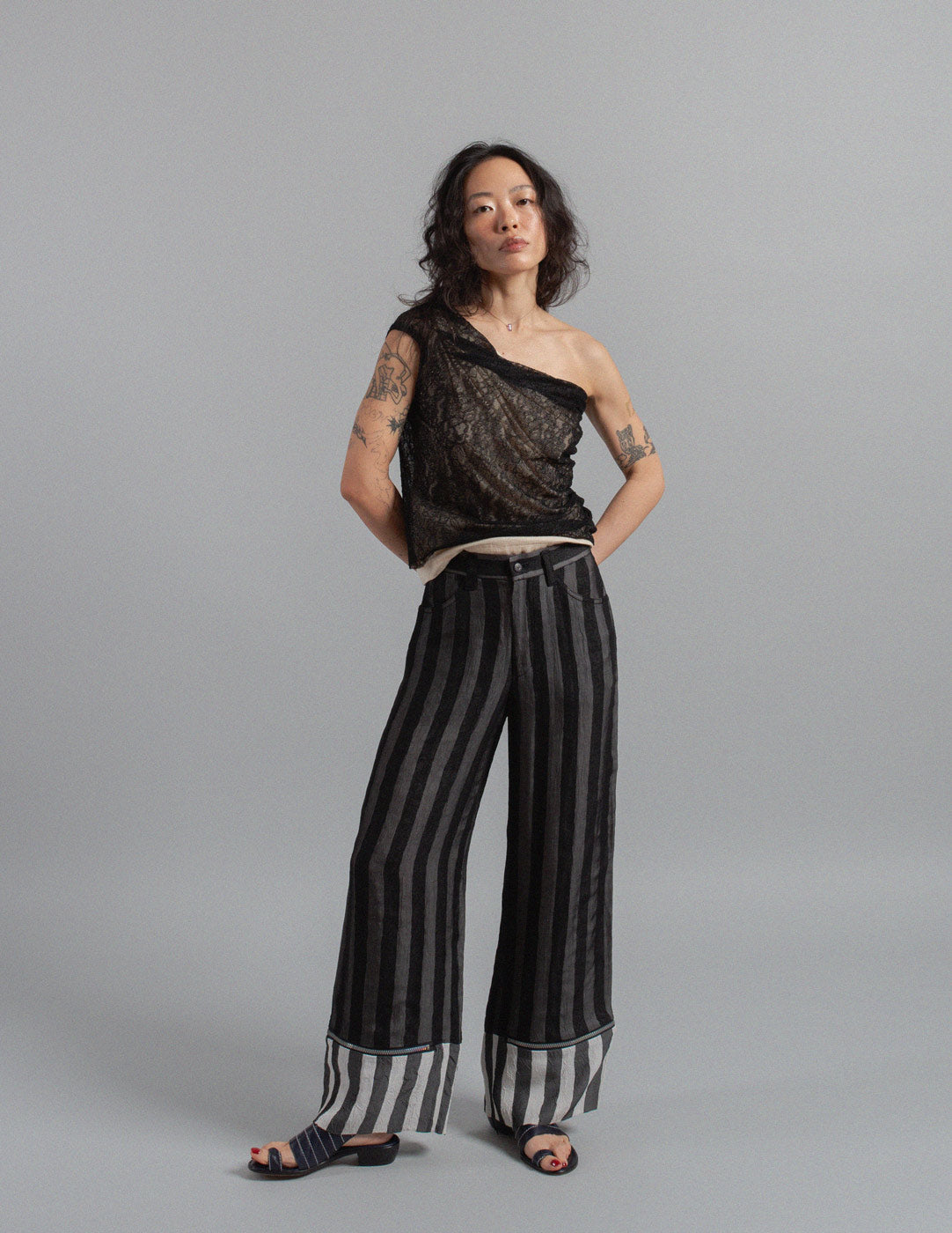 Issey Miyake layered striped trousers with zipped cuffs