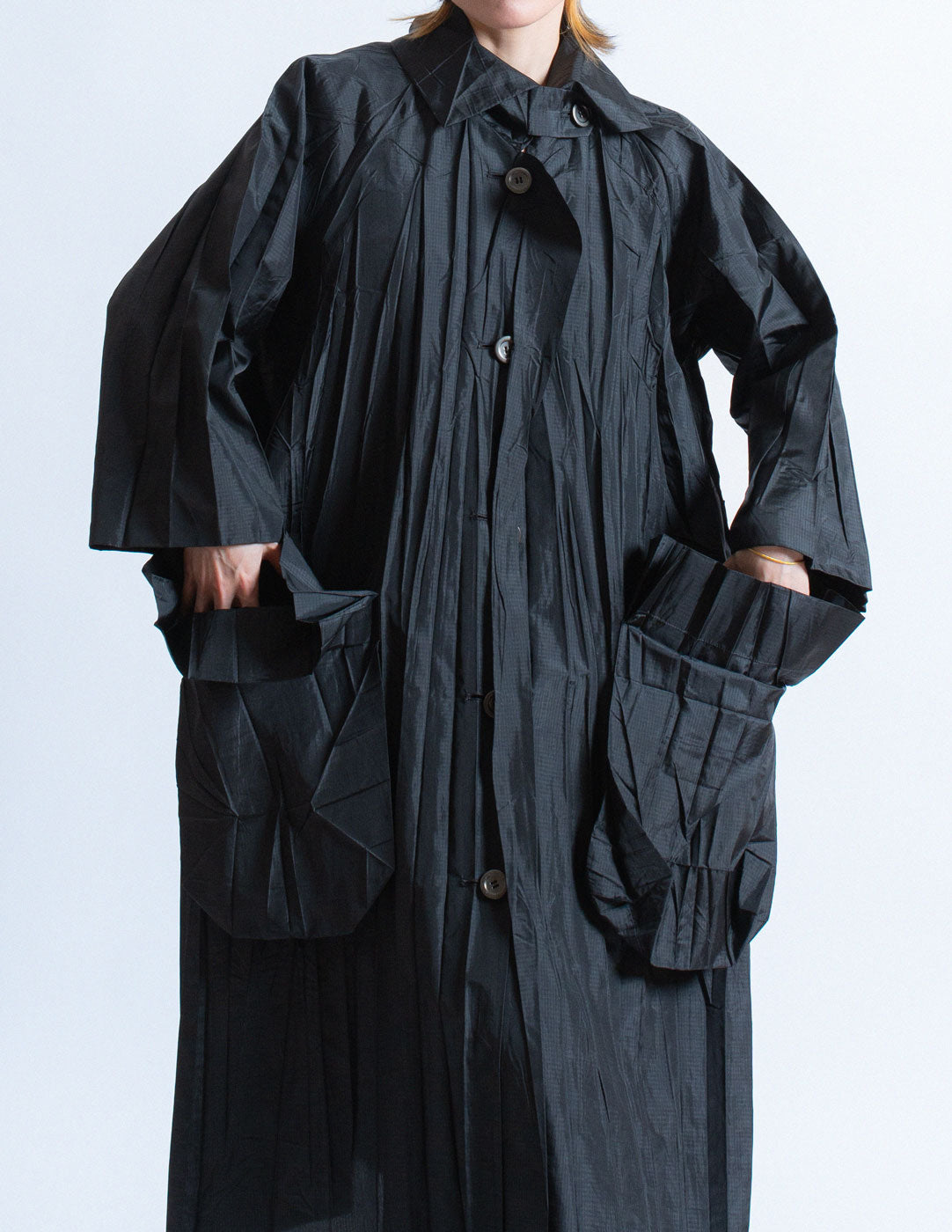 Issey Miayke black pleated spring coat front detail