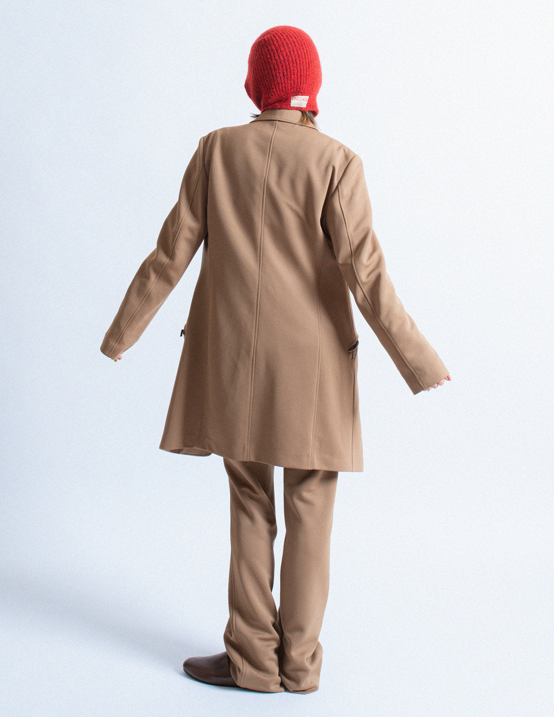 Issey Miyake camel tone long blazer and trousers set back view
