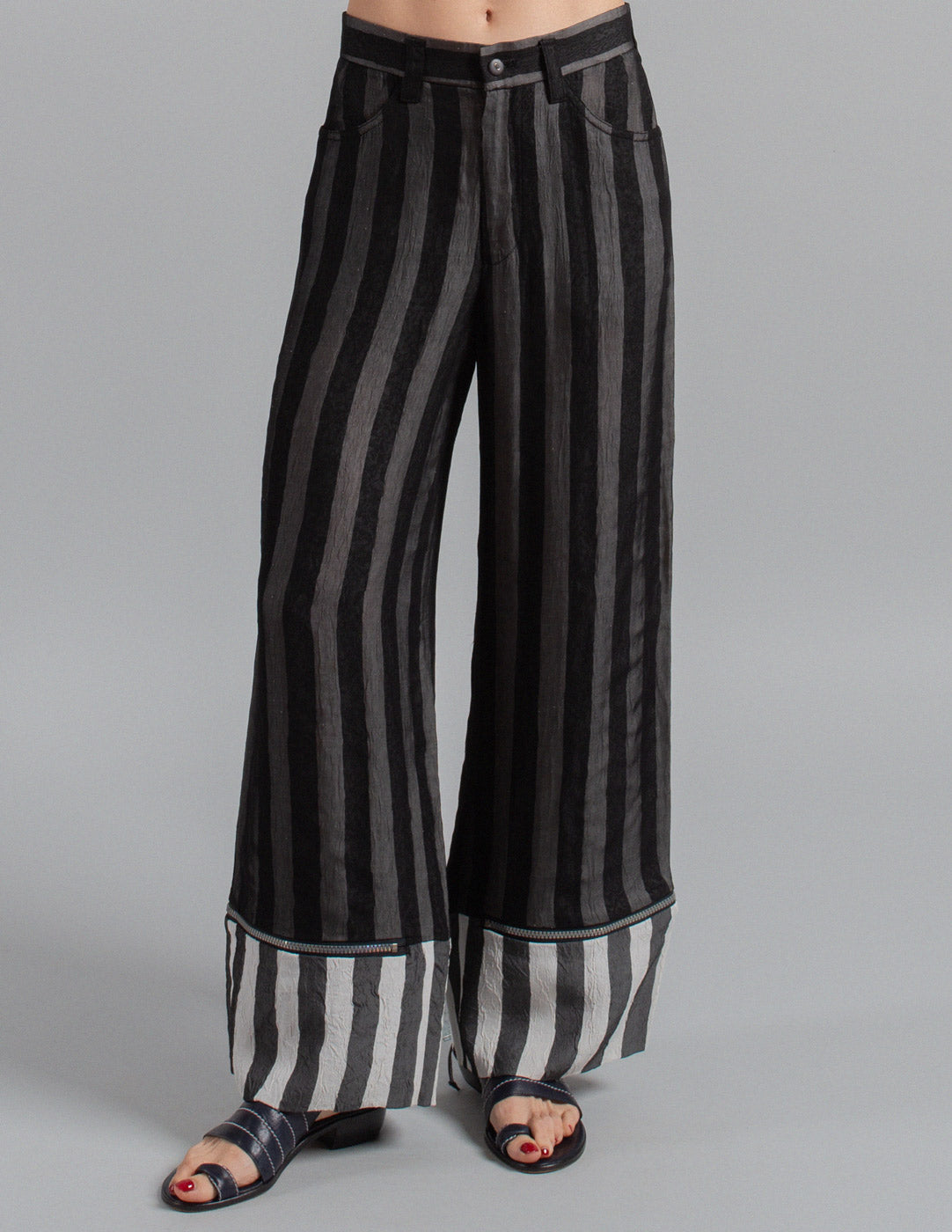 Issey Miyake layered striped trousers with zipped cuffs front detail
