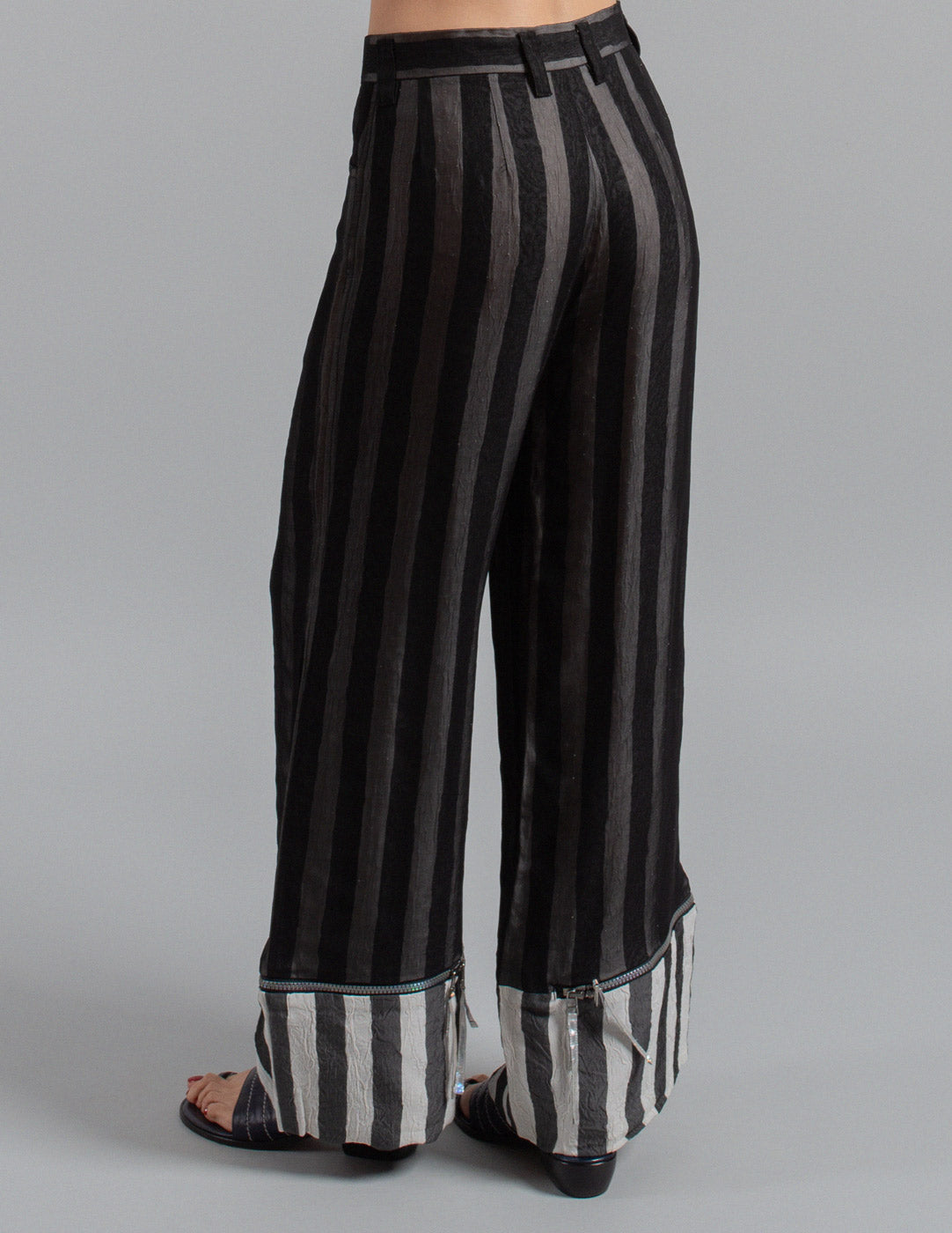 Issey Miyake layered striped trousers with zipped cuffs back detail