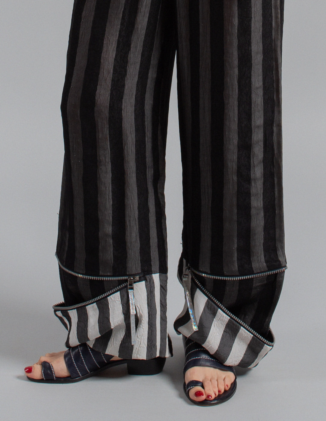 Issey Miyake layered striped trousers with zipped cuffs detail