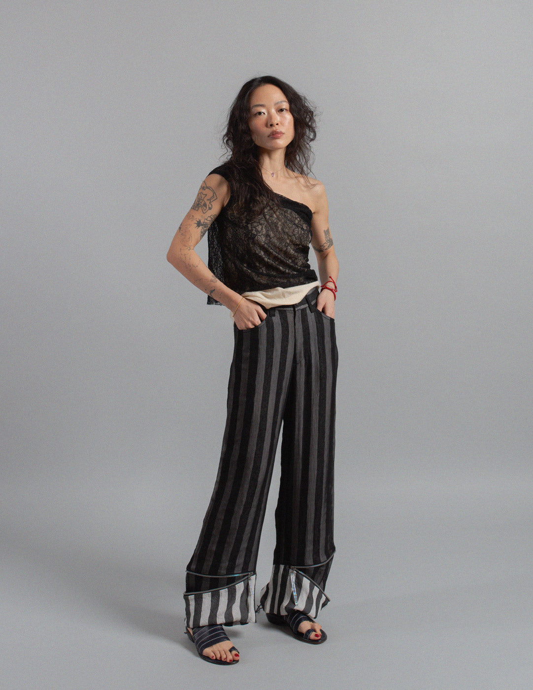 Issey Miyake layered striped trousers with zipped cuffs